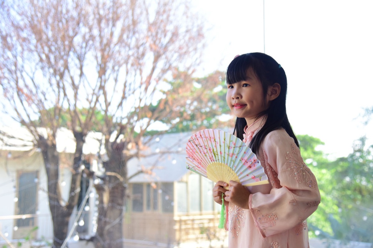 K-pop fan holding a souvenir in a crowded street