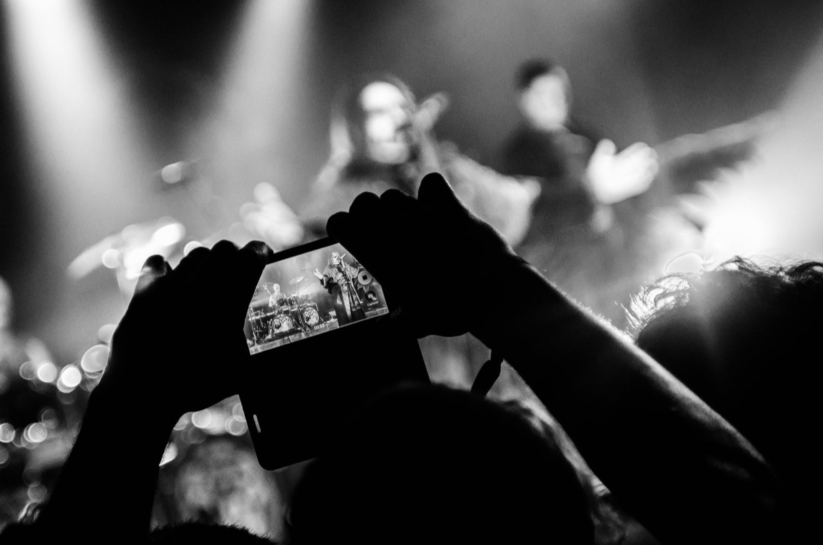 K-pop fan holding smartphone in Seoul street