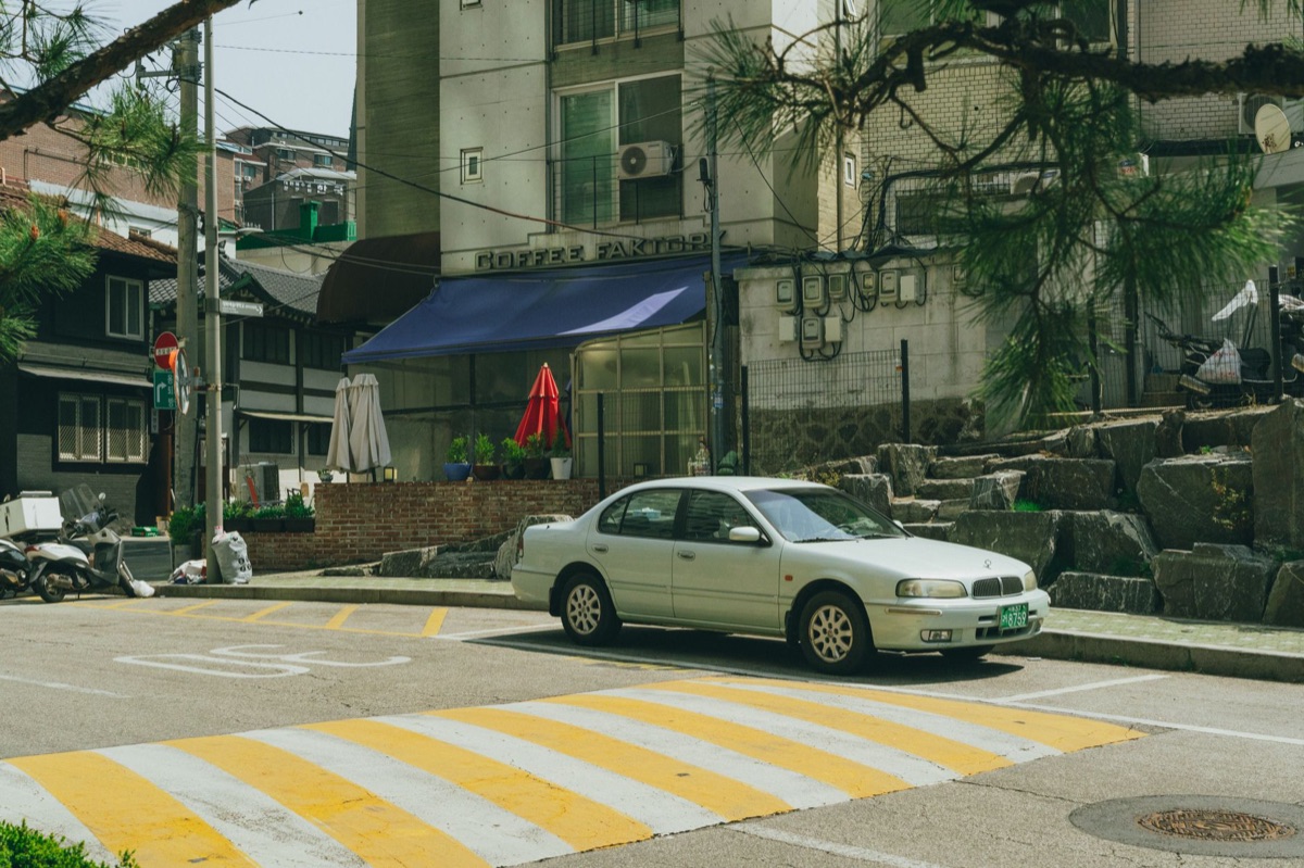 Seoul street corner cafe with customers and street view